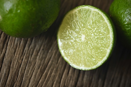 lime slices on wooden table. Detox diet, limes Backgrounds, Close up shot, fruit macro photographyの写真素材
