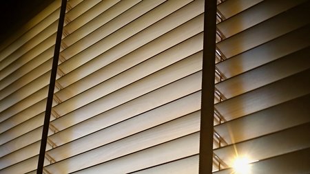 Evening sun light outside wooden window blinds, sunshine and shadow on window blind and, decorative interior home conceptの写真素材