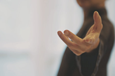 Giving a helping hand, asking or offering help close-up shot of a Business man in a business suit.