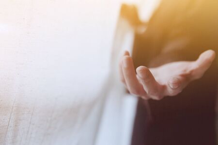 Giving a helping hand, asking or offering help close-up shot of a Business man in a business suit.の写真素材
