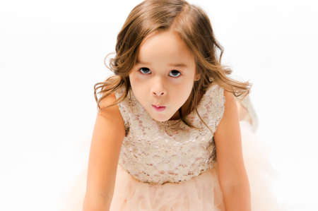 Portrait of happy pretty curly little girl posing over white background , girl smiling , happy feelingの写真素材