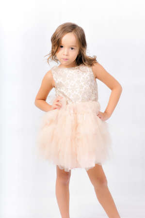 Portrait of happy pretty curly little girl posing over white background , girl smiling , happy feelingの写真素材