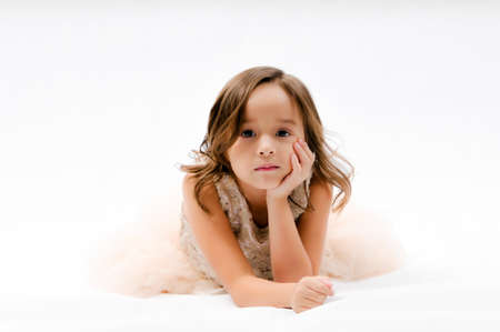 Portrait of happy pretty curly little girl posing over white background , girl smiling , happy feelingの写真素材