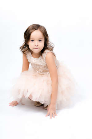 Portrait of happy pretty curly little girl posing over white background , girl smiling , happy feelingの写真素材