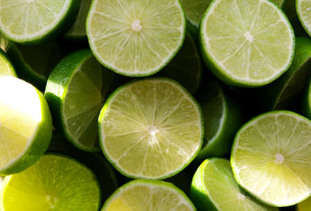 Lime Background with sun light from outside. Close up shot of limes. Selective Focus of sliced lime. Lime is a kind of fruit. The result is very sour for cook the Thai food styleの写真素材