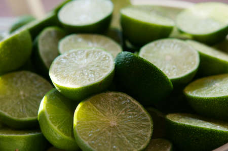 Lime Background with sun light from outside. Close up shot of limes. Selective Focus of sliced lime. Lime is a kind of fruit. The result is very sour for cook the Thai food styleの写真素材