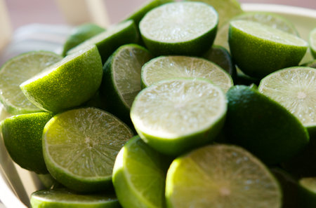 Lime Background with sun light from outside. Close up shot of limes. Selective Focus of sliced lime. Lime is a kind of fruit. The result is very sour for cook the Thai food styleの写真素材