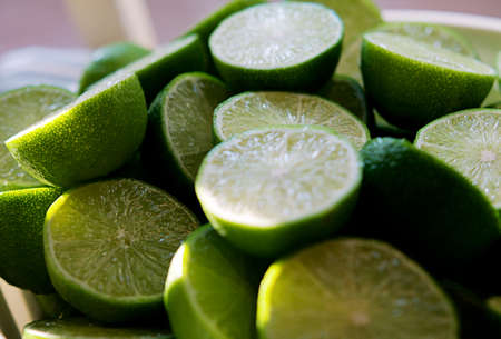 Lime Background with sun light from outside. Close up shot of limes. Selective Focus of sliced lime. Lime is a kind of fruit. The result is very sour for cook the Thai food styleの写真素材