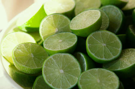 Lime Background with sun light from outside. Close up shot of limes. Selective Focus of sliced lime. Lime is a kind of fruit. The result is very sour for cook the Thai food styleの写真素材