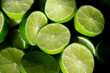 Lime Background with sun light from outside. Close up shot of limes. Selective Focus of sliced lime. Lime is a kind of fruit. The result is very sour for cook the Thai food styleの写真素材