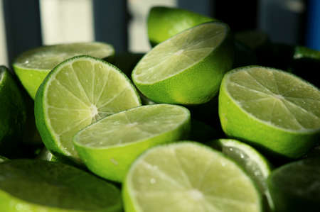 Lime Background with sun light from outside. Close up shot of limes. Selective Focus of sliced lime. Lime is a kind of fruit. The result is very sour for cook the Thai food styleの写真素材