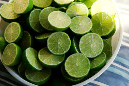 Lime Background with sun light from outside. Close up shot of limes. Selective Focus of sliced lime. Lime is a kind of fruit. The result is very sour for cook the Thai food styleの写真素材