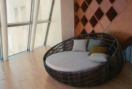 comfortable sofa (round form) in the living room, sunlight outside from glass windowの写真素材