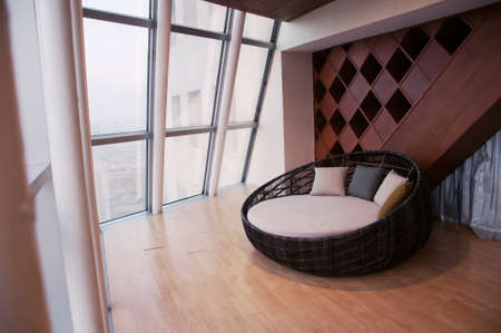 comfortable sofa (round form) in the living room, sunlight outside from glass windowの写真素材