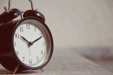 Retro alarm clock on the table. Selective focus. Toned.の写真素材