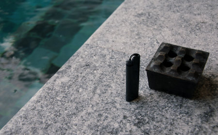 A black brick on the edge of a swimming pool, close-upの写真素材