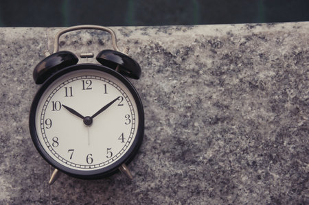 Retro alarm clock on the street. Time concept. Selective focus.の写真素材