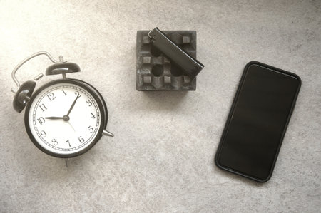 Smartphone with alarm clock on the table. Time management concept.の写真素材