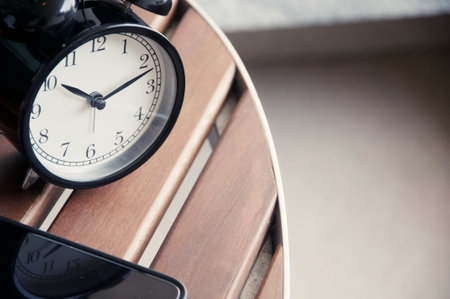 Close-up of the alarm clock on the wooden table. Time conceptの写真素材