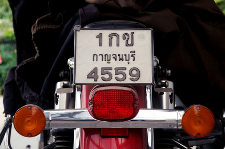 Kanchanaburi, Thailand -  January,14, 2022, Thai Motorcycle Plate license .  Rear view of part of vintage retro red motorcycleのeditorial素材