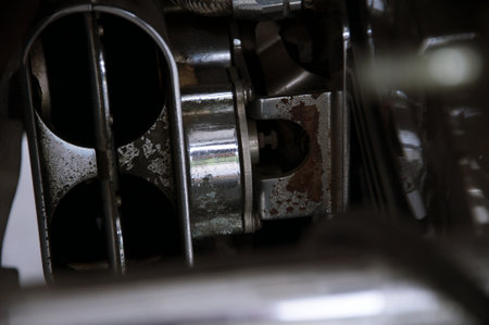 Several motorcycles standing in row in garage forming abstract background of metal partsの写真素材