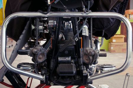 Several motorcycles standing in row in garage forming abstract background of metal partsの写真素材