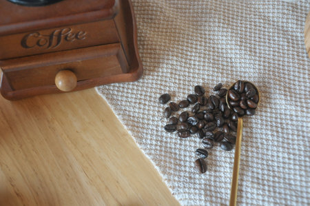 Coffee beans and coffee grinder on the wooden table.の写真素材