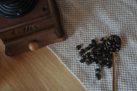 Coffee grinder and coffee beans on wooden table. Coffee background.の写真素材