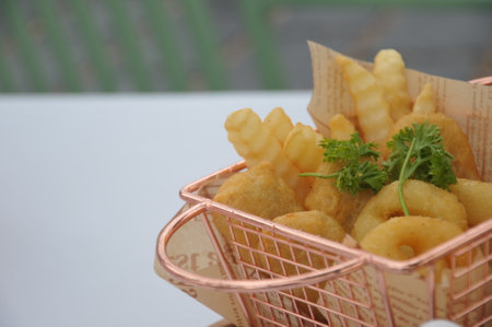 French fries in basket on the table, closeup of photo.の写真素材