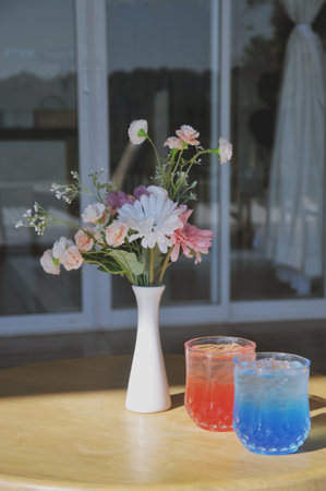 Bouquet of flowers in a vase on a wooden tableの写真素材