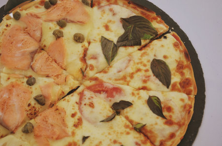 Pizza with salmon, mozzarella cheese and olive oil.の写真素材