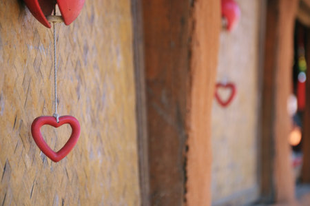 Red heart hanging on the wall of an old house in Hoi An, Vietnamの写真素材