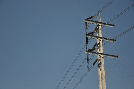 electricity post on blue sky background, closeup of photo.の写真素材