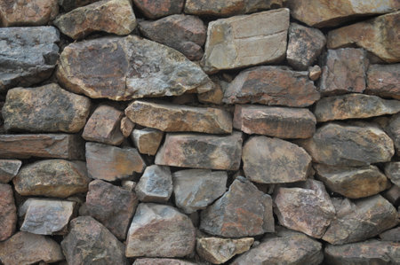 Background of stone wall texture. Close up. Selective focus.の写真素材