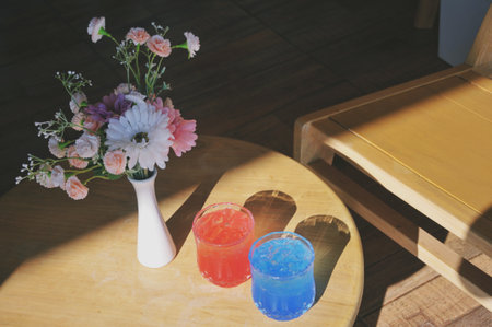 Colorful paints and vase with flowers on the wooden table.の写真素材