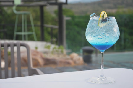 Blue Curacao Cocktail with Lemon and Ice on the Tableの写真素材