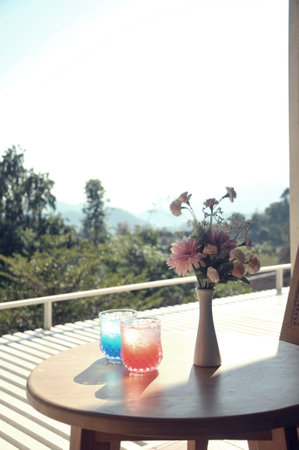 Vase of flowers on the balcony with a view of the mountainsの写真素材
