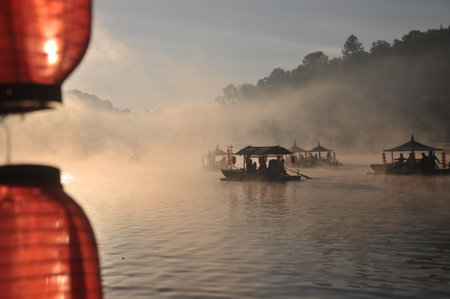 Fishing boat on the river with fog in the morning, Thailandの写真素材