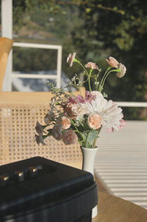 Flowers in a vase on a table in the garden.の写真素材