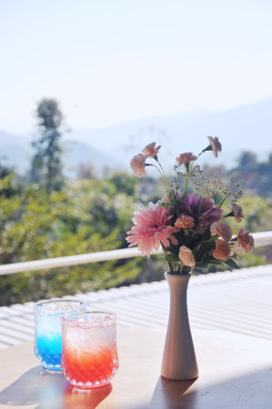 Vase of flowers and cocktails on the terrace in the morningの写真素材