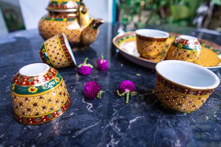 Antique Benjarong porcelain golden tea set on Stone table, ceramics porcelainの写真素材