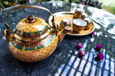 Antique Benjarong porcelain golden tea set on Stone table, ceramics porcelainの写真素材