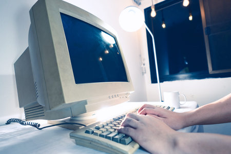 A man using an old personal computer . Ancient concept