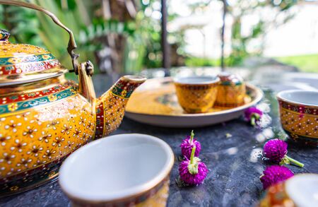 Antique Benjarong porcelain golden tea set on Stone table, ceramics porcelainの写真素材