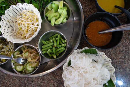 Rice noodles and vegetable side dish. Traditional Thai food Noodle from rice Topped with curry Eaten with vegetablesの写真素材