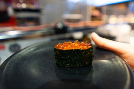Salmon Roe Sushi on a black dish in a Japanese restaurantの写真素材