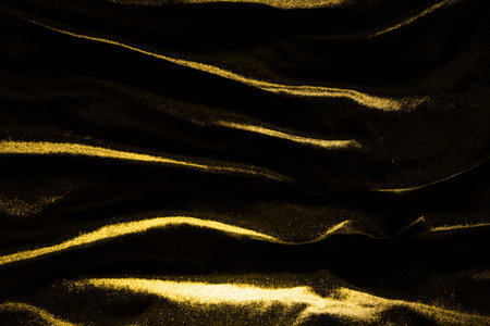 Gold luxury satin fabric texture and shadow for backgroundの写真素材