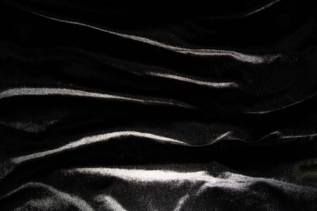 Black silk fabric background abstract Smooth and elegant background use with copy space, close-up and wallpaperの写真素材