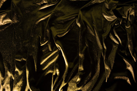 Gold luxury satin fabric texture and shadow for backgroundの写真素材