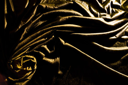 Gold luxury satin fabric texture and shadow for backgroundの写真素材